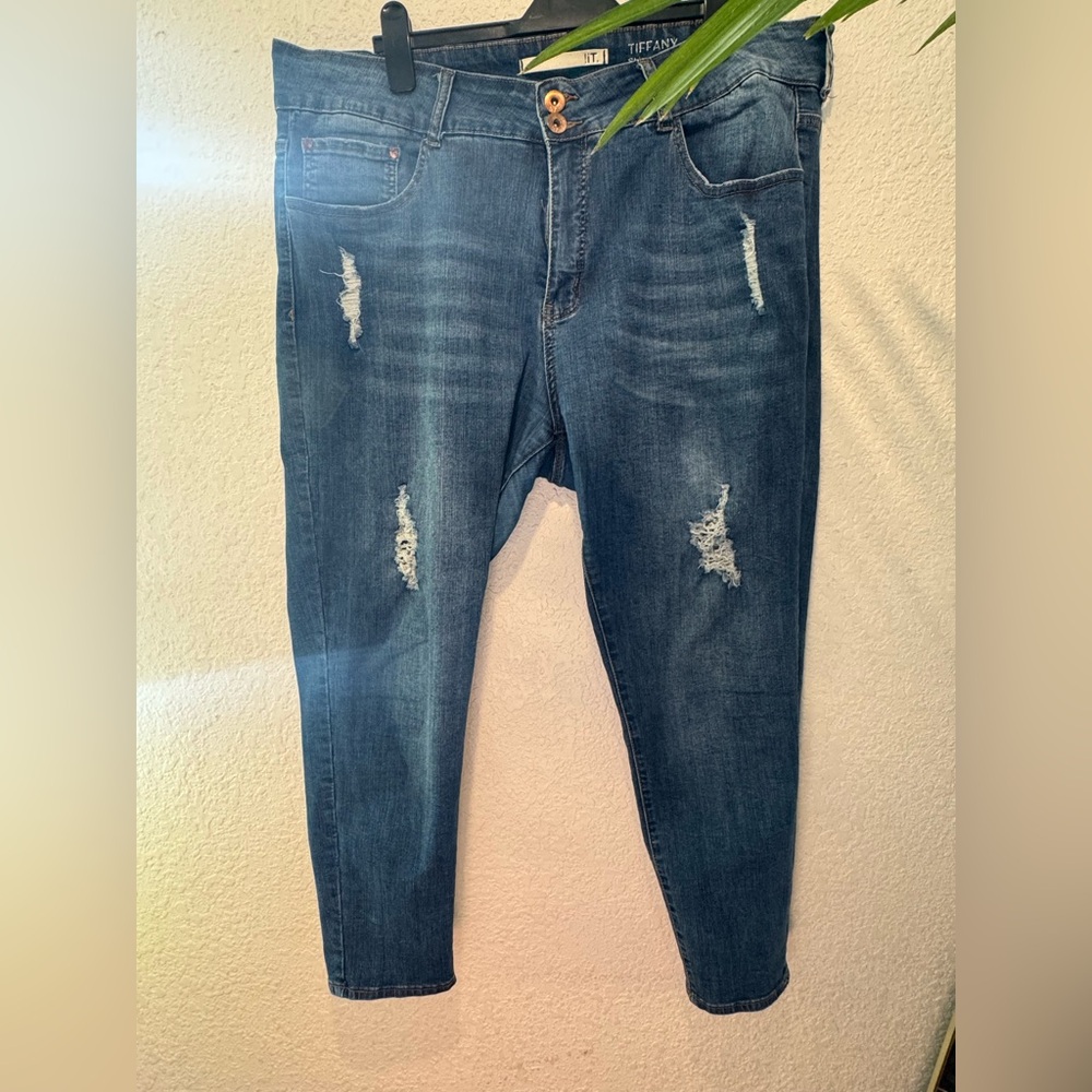 Distressed dark denim jean